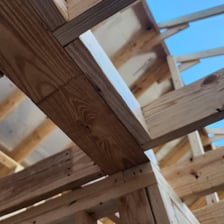 A horizontal wooden beam serving as a crosspiece in a structure