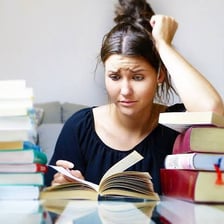 A college student concentrating while working on an academic assignment.