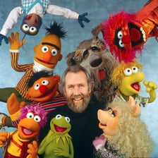 Jim Henson shown with Muppet characters.
