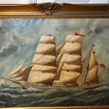 A historic barque sailing ship with multiple masts underway