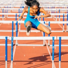 A person jumping over a hurdle