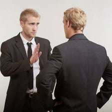 An assertive person speaking insistently to another person