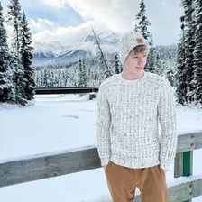 Person wearing a warm sweater in a chilly setting