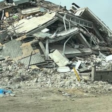 Damaged buildings and rubble after an earthquake.