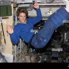 An astronaut floating inside a spacecraft cabin in apparent weightlessness