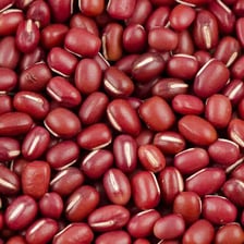 Small reddish-brown adzuki beans displayed in a bowl.