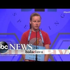 Spelling bee contestant attempting to spell a word at a microphone