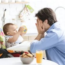 An adult covering their face while playing peekaboo with a toddler
