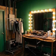 A performer waits in a backstage green room.