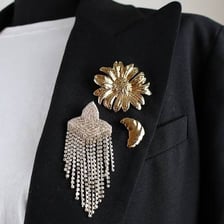 A decorative brooch fastened to a coat with its pin.