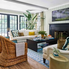 A living room equipped with chairs and a sofa.