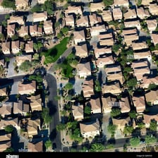 A suburban neighborhood spreading out along the edge of a city
