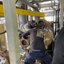 A technician installing equipment at a work site.