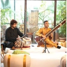 An Indian classical musician performing a raga on a sitar