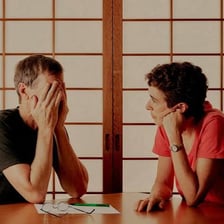 Two people facing each other during a heated argument.