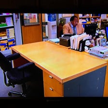 A person leaving an office that has been cleared out.