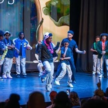 Performers presenting a short comedic sketch onstage