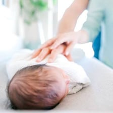 Parent gently soothing a child who is falling asleep