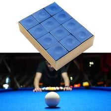A small cube of blue billiards chalk beside a pool cue