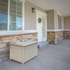 A home entrance with parcels resting on a front porch.
