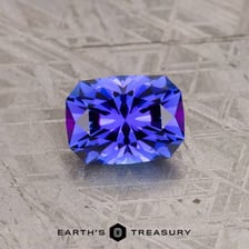 A blue-violet tanzanite gemstone shown close up.