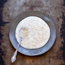 A bowl containing thin, watery porridge.