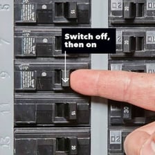 An electrical circuit breaker shown in the tripped position.