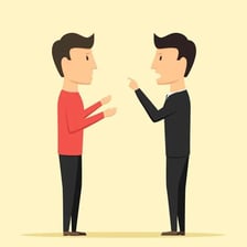 One person sternly correcting another during a conversation.