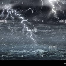 Dark storm clouds over a landscape with heavy rain and strong wind.