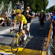 A cyclist wearing the yellow leader’s jersey in the Tour de France