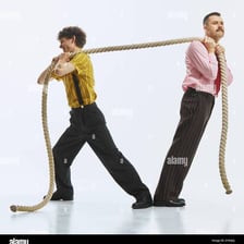 A person pulling forcefully on a rope