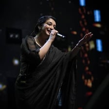 A singer performing gentle, melodious music