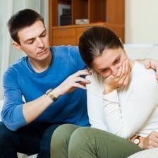 One person apologizing to another in a conversation.