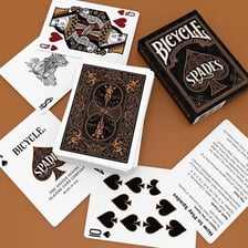 Playing cards displaying the spades suit.