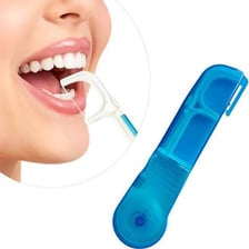 Dental floss being used to clean between teeth