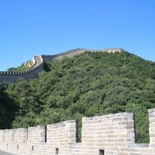 A stone parapet along the top of a fortress wall