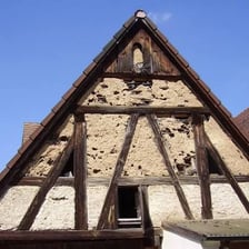 A traditional wall made from woven branches covered with plaster-like daub.