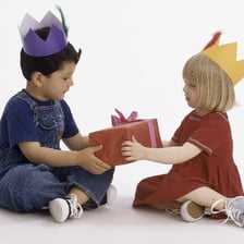 Children sitting in a circle and playing pass the parcel