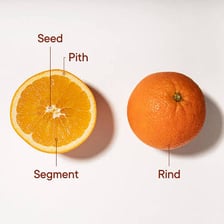 A cut orange showing the white pith beneath the outer peel.