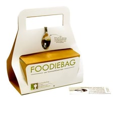 A takeaway container holding leftover restaurant food