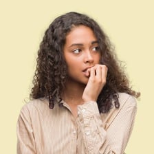 A nervous person biting a fingernail