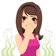 A person reacting to a bad smell by covering their nose