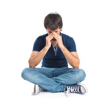 A person sitting with a visibly dejected expression
