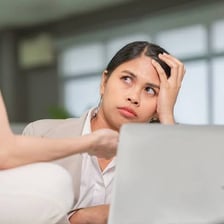 A person reacting with embarrassment after making an obvious mistake.