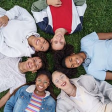 A small close-knit social group standing together.