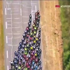 Cyclists competing in a Tour de France road-race peloton