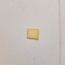 A close-up of thick sticky residue on a surface.