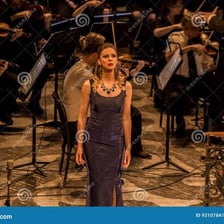 An opera singer performing on a theatrical stage