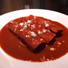 A traditional enchilada made from a rolled tortilla covered with sauce.