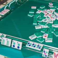 A set of decorated mahjong tiles arranged on a table.